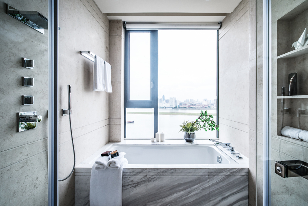 Spacious,bathroom,in,gray,tones,with,heated,floors,,freestanding,tub,